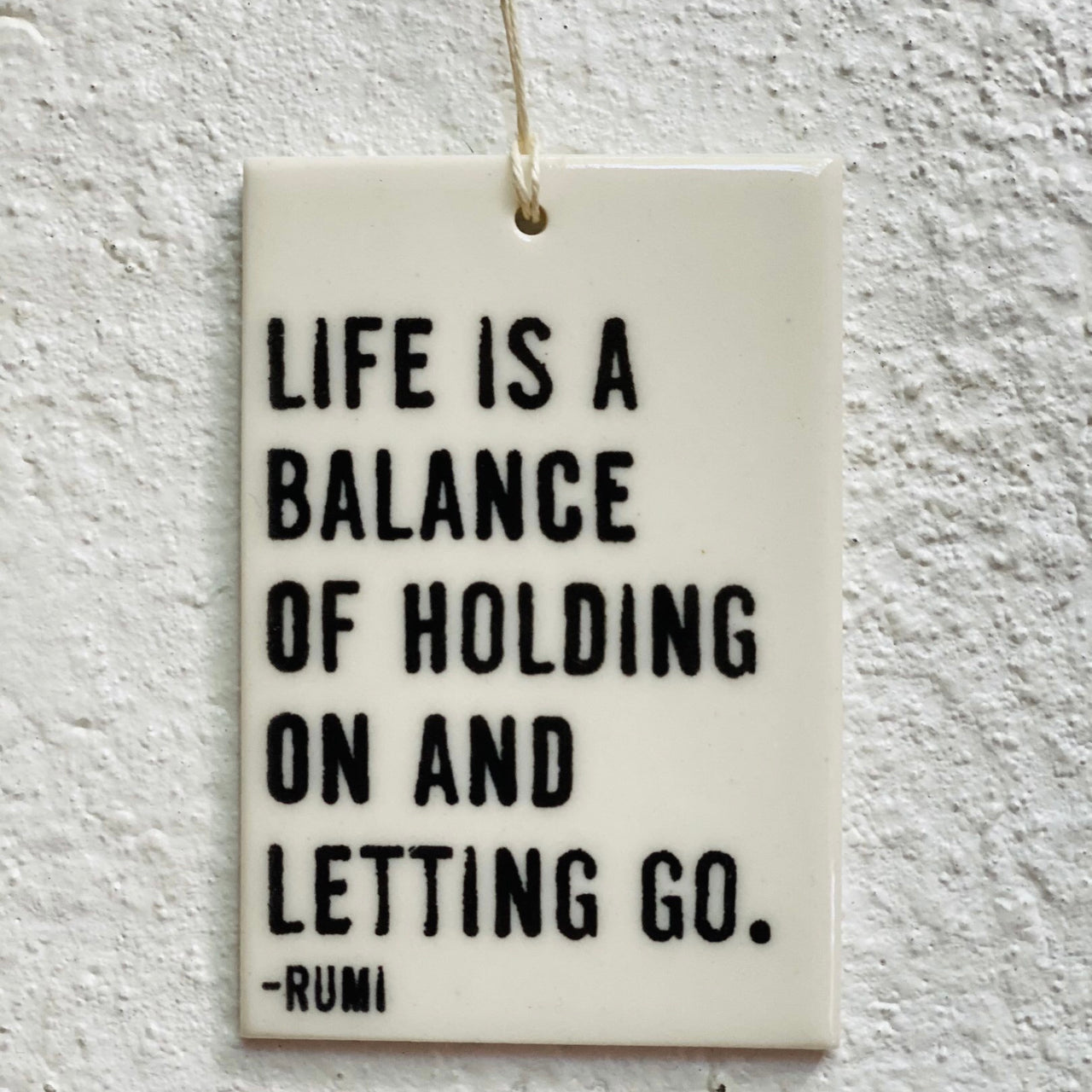 Life is a balance of holding on and letting go-  porcelain tag